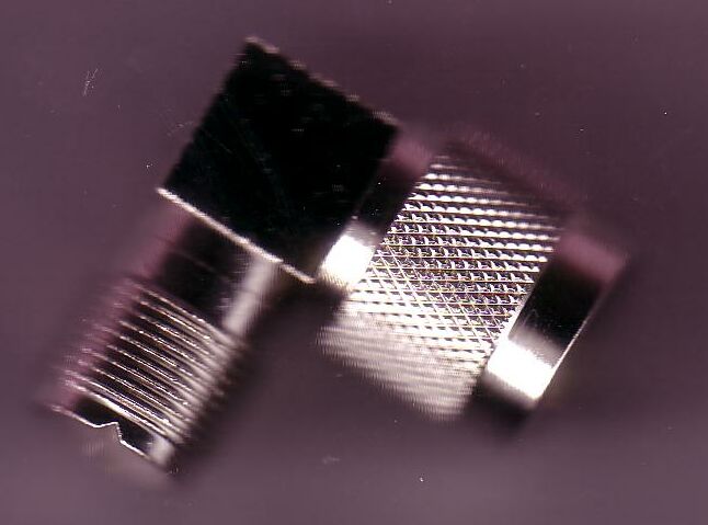 Silver color Collins wattmeter on a black background